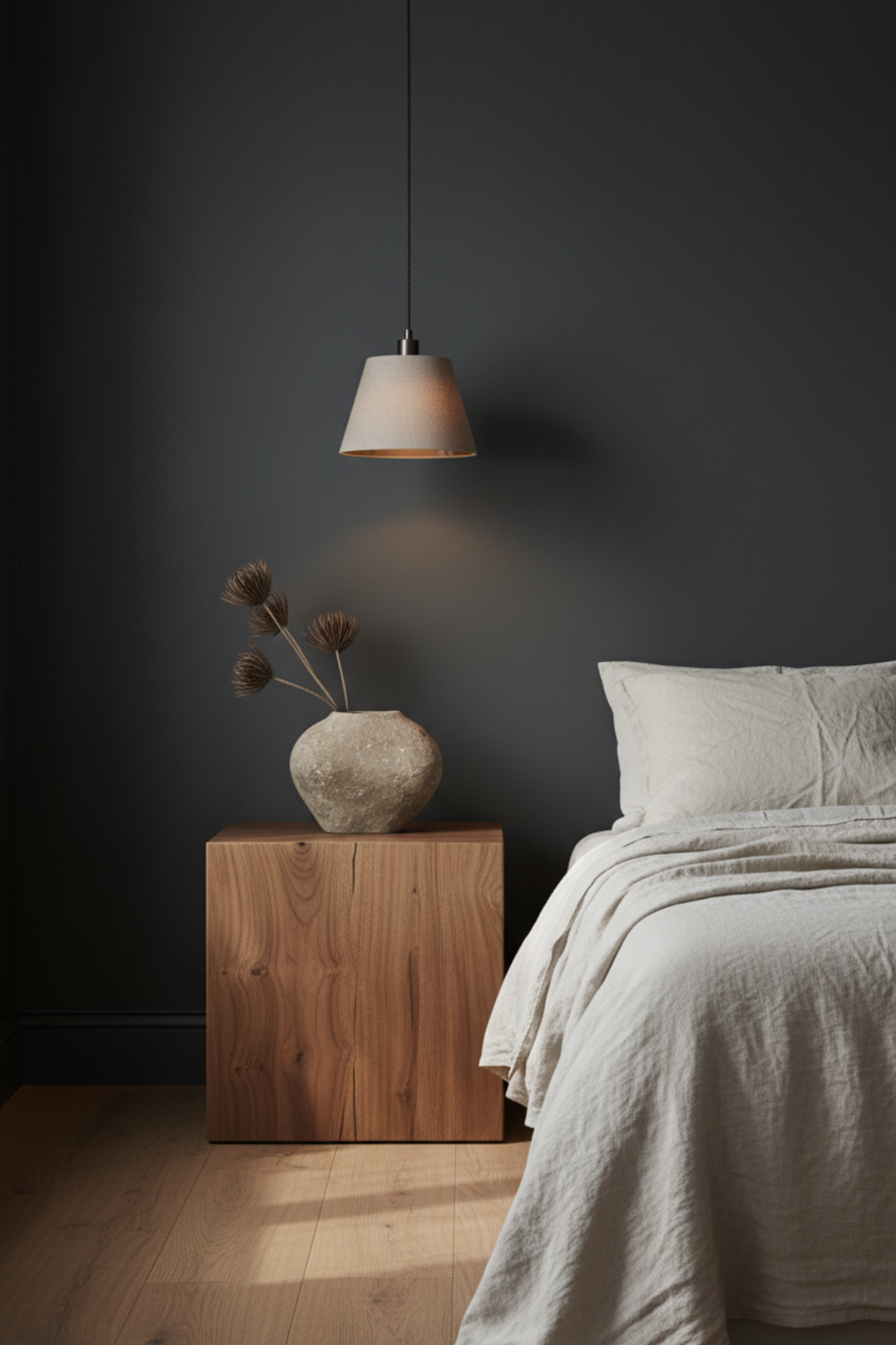 Dark walnut wood nightstand and furniture adding warmth to a moody bedroom