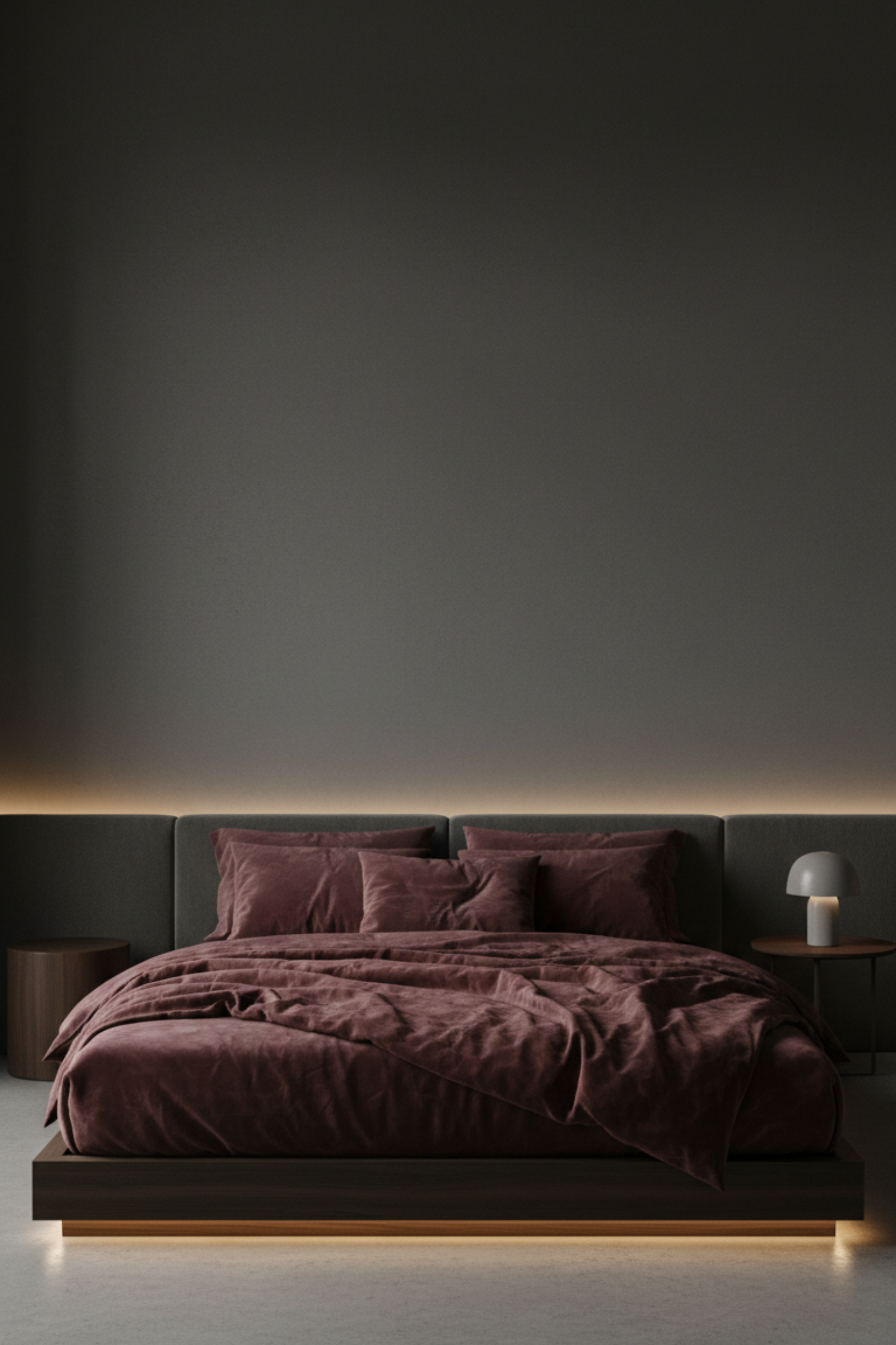 Low-profile platform bed creating a grounded intimate feel in a moody bedroom